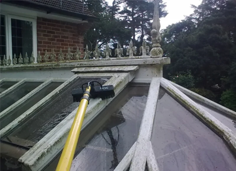 Water-fed brush cleaning a conservatory roof from the Albright portfolio
